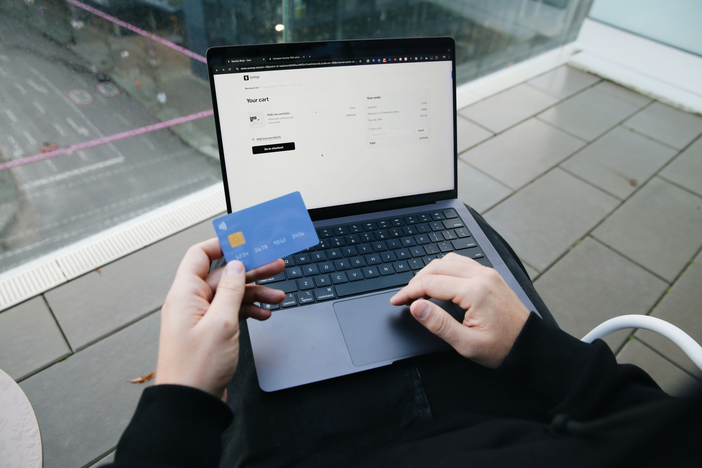 Build an online store - completing checkout on a laptop with a credit card in hand